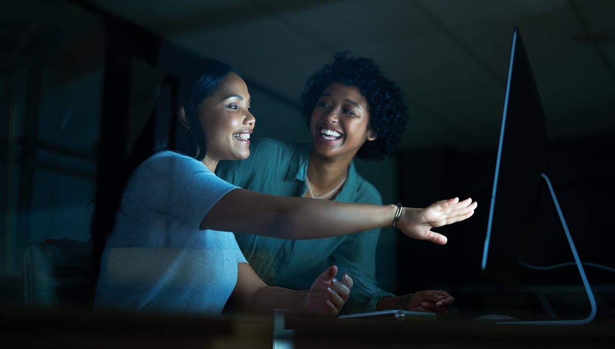 Two colleagues working together on a computer