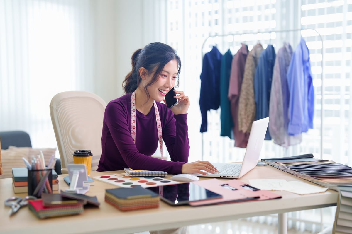 Business owner working on branding at a creative studio desk